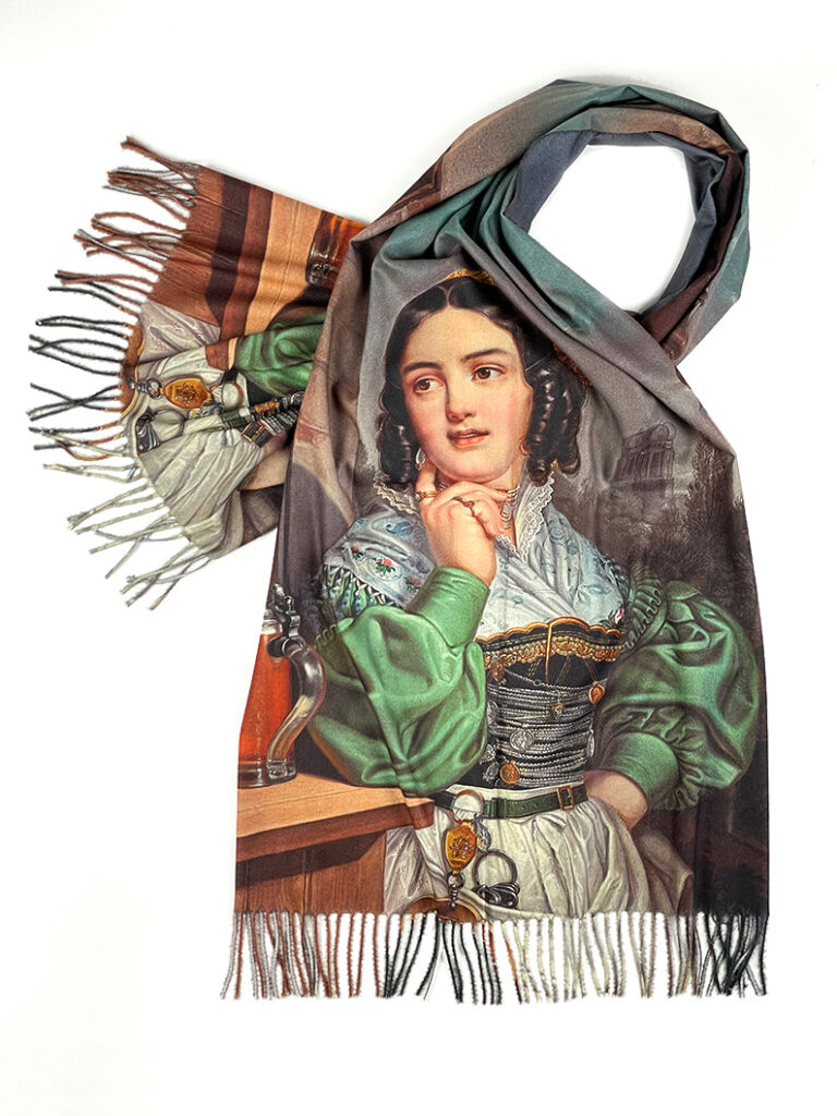 Dieser Schal unserer Trachtenmode zeigt das Bild "Coletta - die schönste Kellnerin Münchens" von W. Wanderer (1841)
 - Eine Frau steht im grünen Dirndl neben einem Tisch